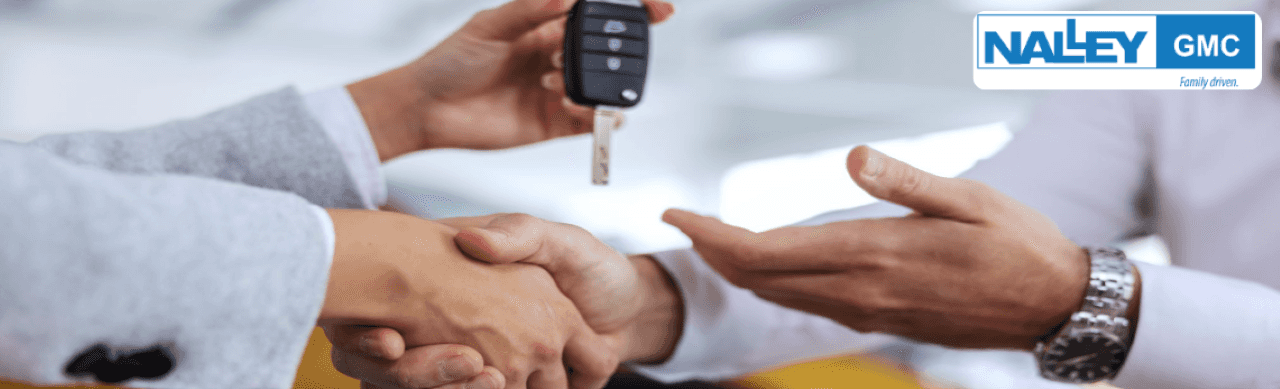 GMC dealership associate appraising a vehicle for Max Allowance trade-in at Nalley Brunswick GMC in Brunswick, GA.