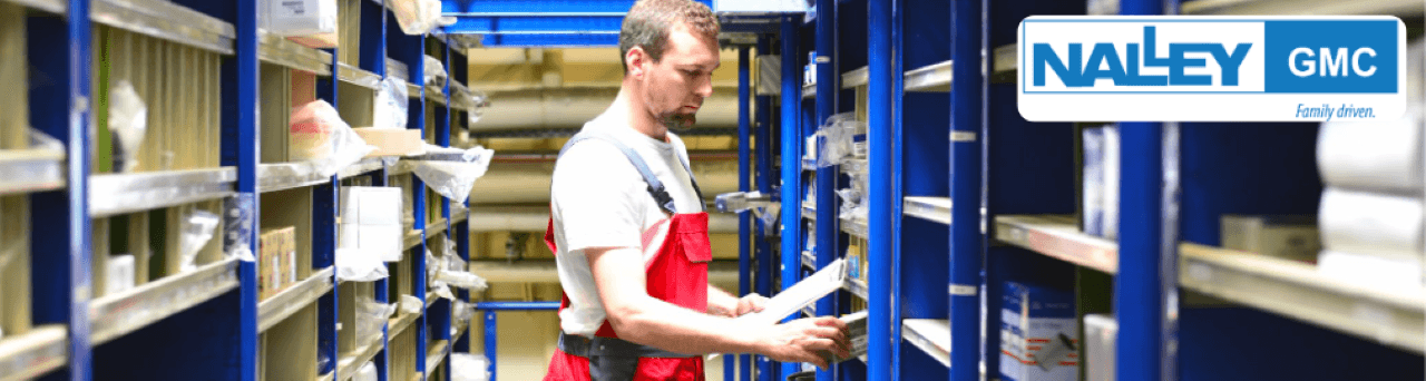 A GMC service technician is searching for OEM brake components at Nalley Brunswick GMC.