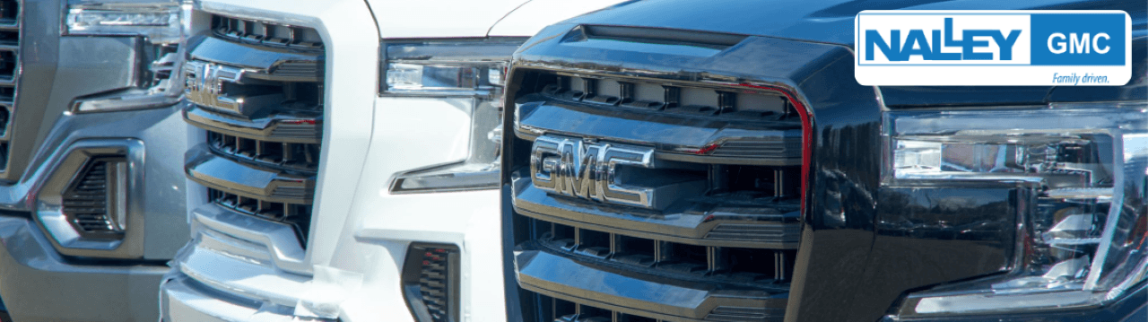 Nalley Brunswick GMC showroom with new and used vehicles lined up under clear skies.