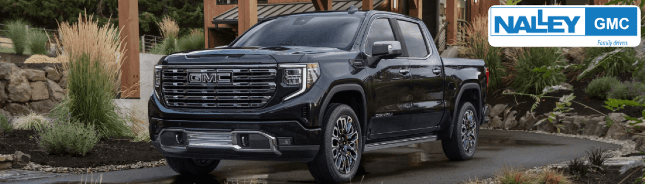 2024 GMC Sierra Denali parked in Brunswick, GA, showcasing its premium chrome grille and rugged yet refined profile.