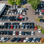 Wide-angle view of Nalley Brunswick GMC car lot featuring new and used vehicles on display.