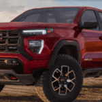 2024 GMC Canyon parked on a rugged trail near Glynn County, showing off its midsize strength and bold design.