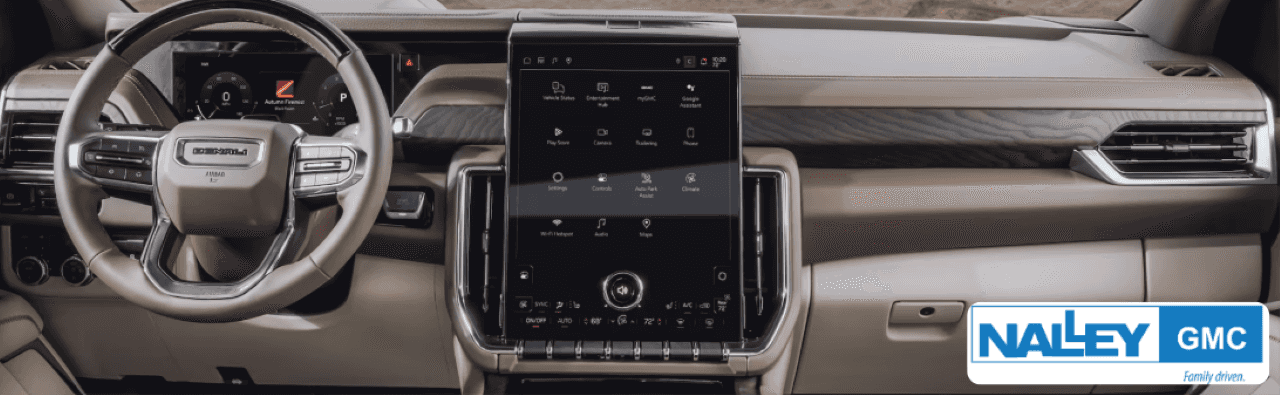 Driver enjoying the premium interior of a GMC YukonDenali while cruising through downtown Brunswick.