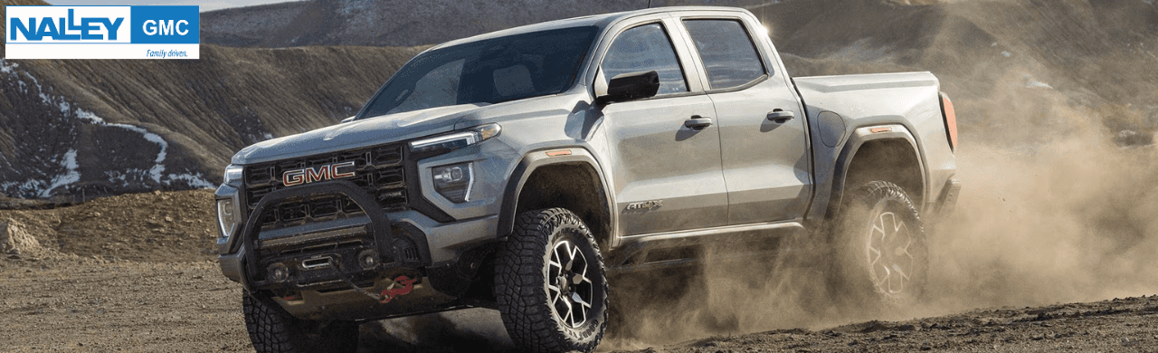 Front three-quarter view of a GMC Canyon Elevation driving through coastal Georgia terrain
