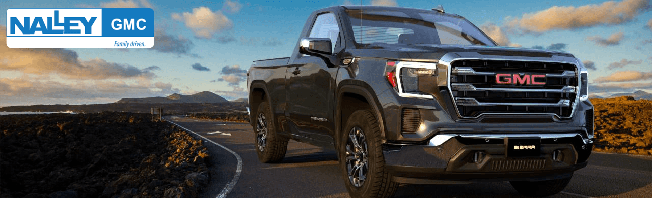 Sales consultant showing a GMC Sierra Diesel truck to a customer at Nalley Brunswick GMC near Savannah, GA