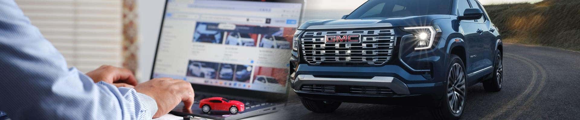 A person browses car images on a laptop next to a miniature red car, while a blue GMC SUV drives on a curved road, symbolizing automotive research and exploration.