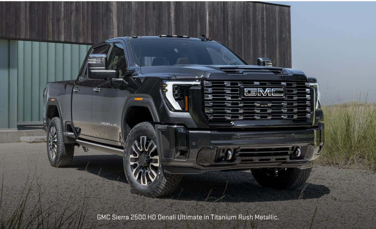 Front three-quarter view of a GMC Sierra 2500HD Denali Ultimate in Titanium Rush Metallic parked.