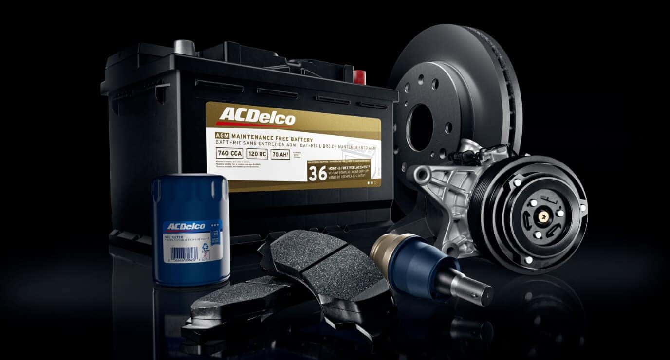 ACDelco OEM parts including battery, oil filter, brake pads, rotor and compressor displayed on a black background.