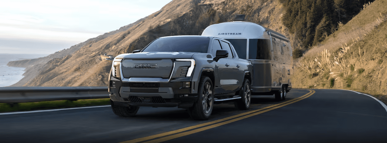 2025 GMC Sierra EV Denali Towing a Cargo