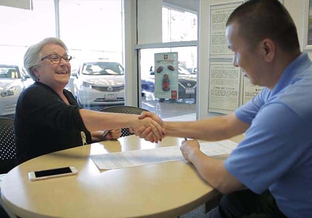 car owner bringing a vehicle in for service at a dealership
