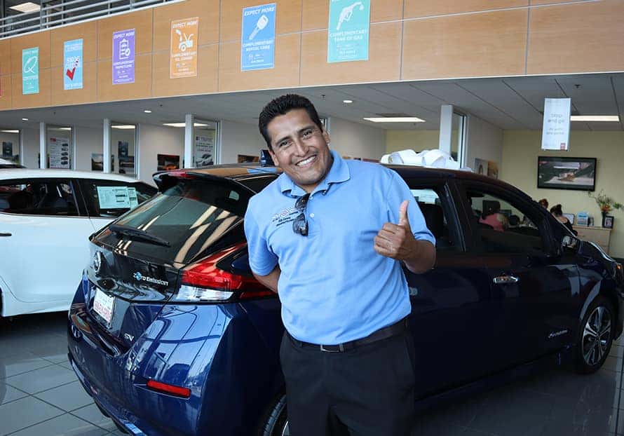 friendly car salesman helping a customer
