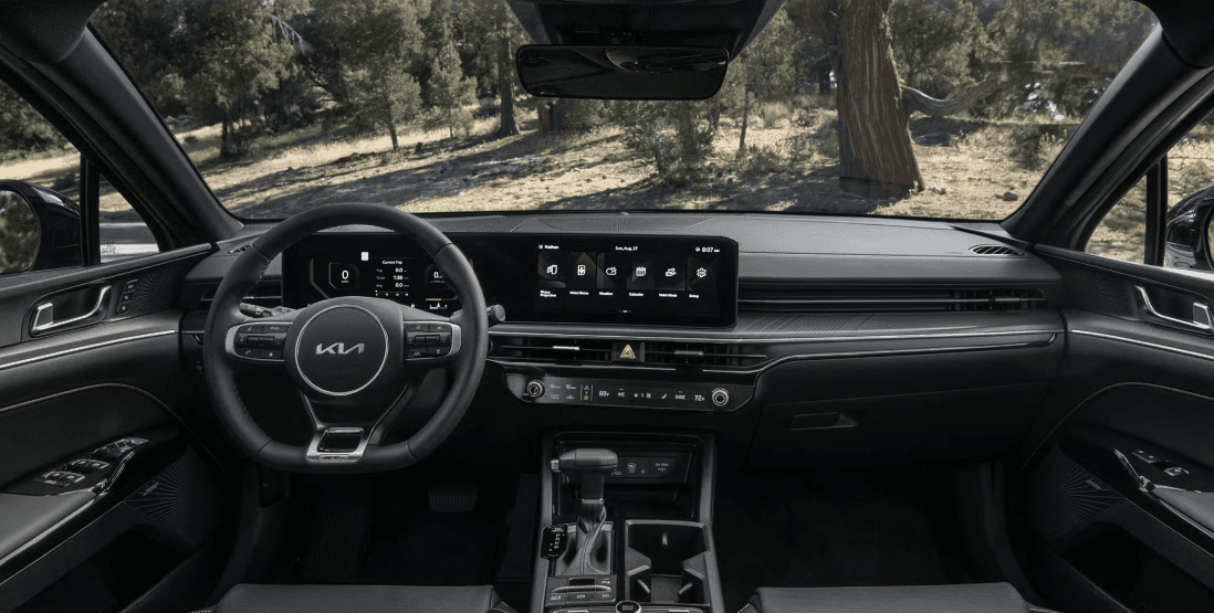 2026 Kia K5 interior dashboard with widescreen display and steering wheel