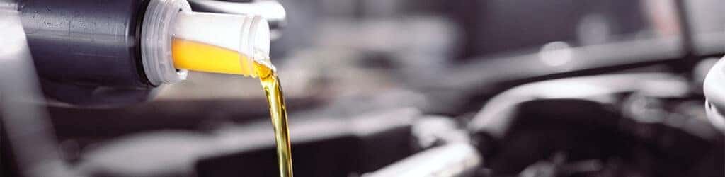 Difference between synthetic oil & conventional oil at Palmiero Toyota | Synthetic oil being poured in car engine 