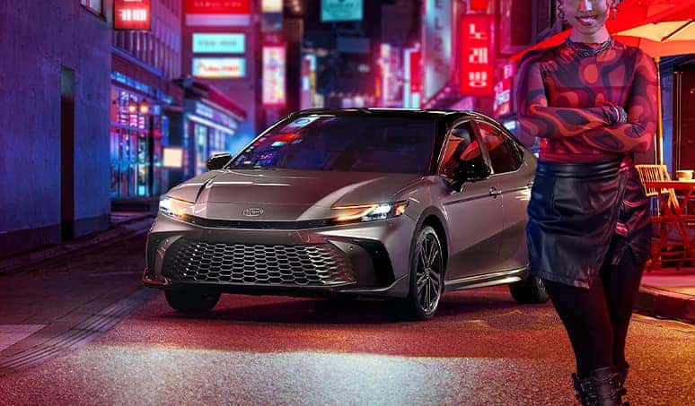 Most Fuel Efficient Toyota Models at Palmiero Toyota | Person standing in front of a new 2024 Toyota Camry in the color silver