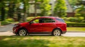 A red 2018 Chevy Equinox is shown after leaving a used Chevy dealer.