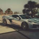 A silver 2023 Chevy Corvette Z06 is shown on a driveway after leaving a Chevrolet Dealer in South Jordan, UT.