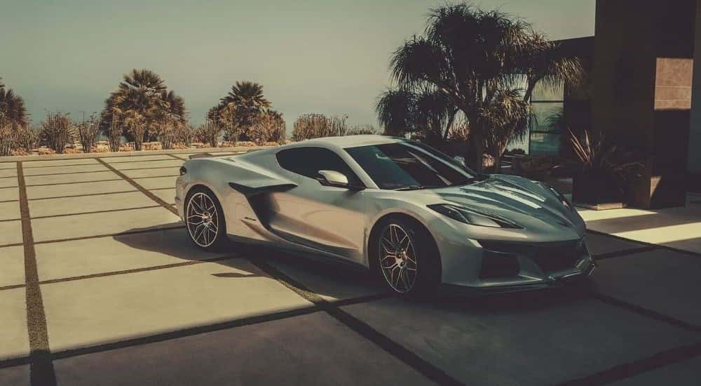 A silver 2023 Chevy Corvette Z06 is shown on a driveway after leaving a Chevrolet Dealer in South Jordan, UT.