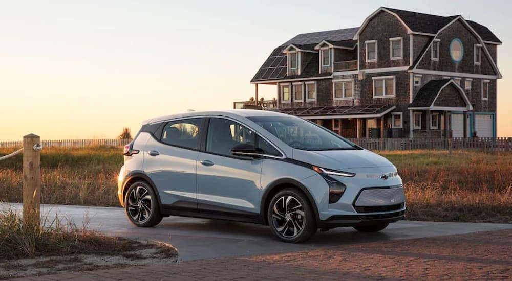A light blue 2022 Chevy Bolt EV is shown parked on a road after visiting a Chevrolet dealer near Provo, UT.