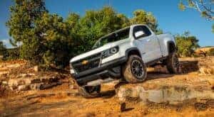 A white 2020 Chevy Colorado ZR2 is shown off-roading.