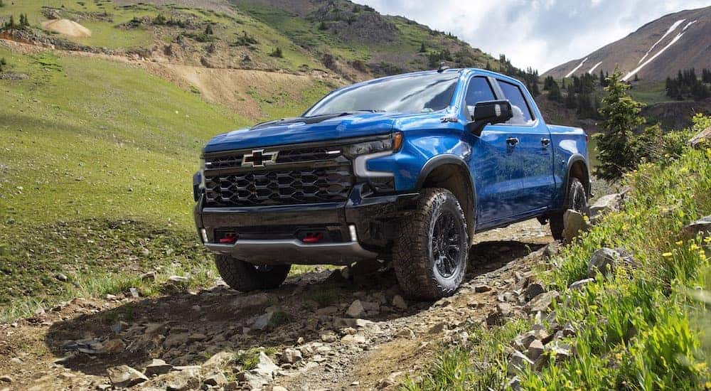 A blue 2022 Chevy Silverado ZR2 is shown from the front at an angle after leaving a used Chevy dealer near Draper, UT.