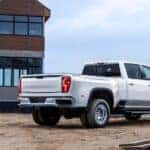 A white 2024 Chevy Silverado 3500 HD LTZ is shown from the rear at an angle.