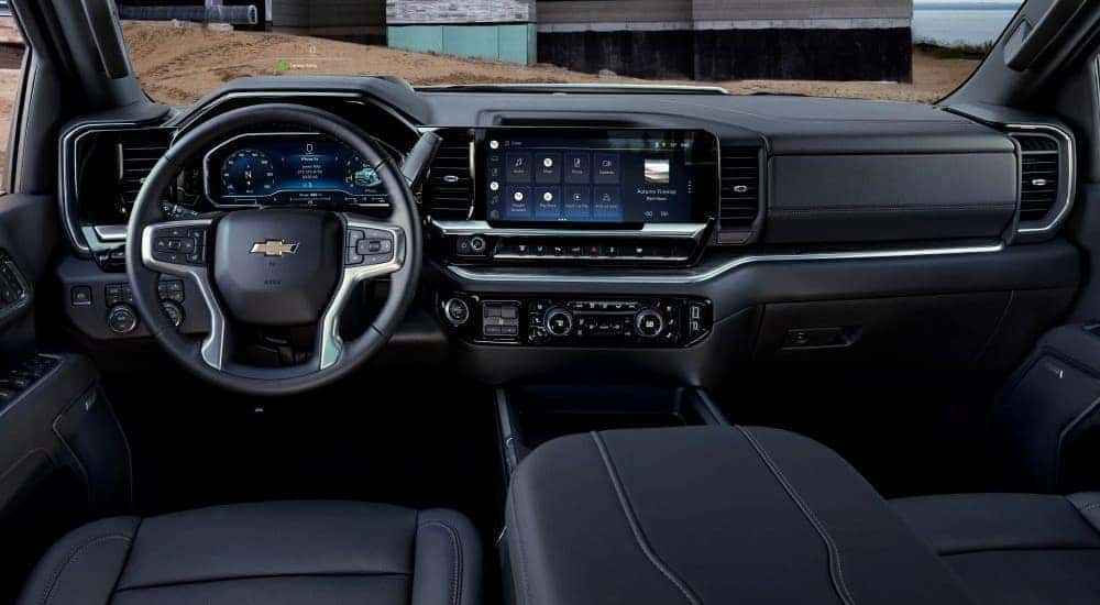 The black interior and dash of a 2024 Chevy Silverado 3500 HD for sale is shown.