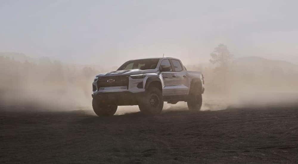 A white 2024 Chevy Colorado ZR2 Bison is shown parked off-road in the fog.