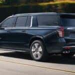 A dark blue 2021 Chevy Suburban High Country is shown from the side after looking at used SUVs for sale.