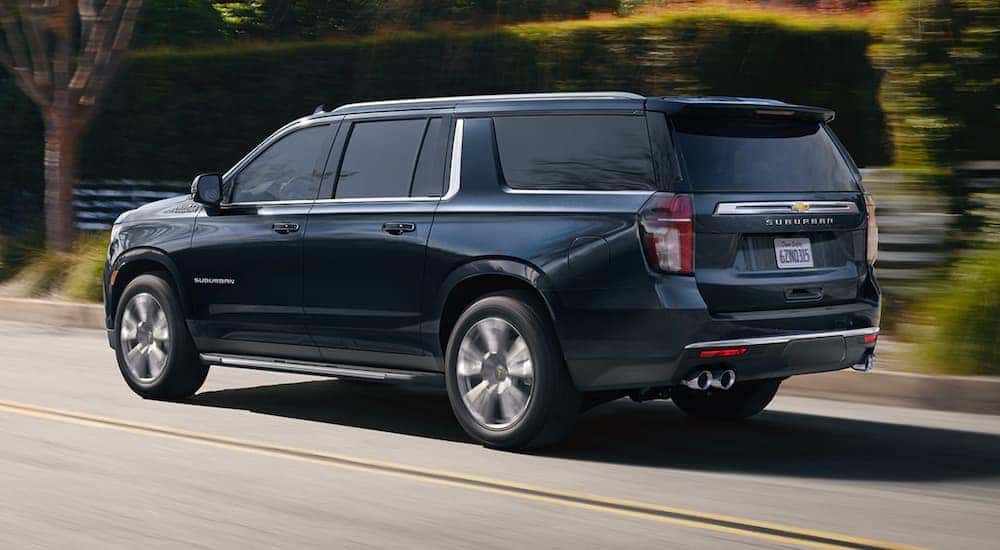 A dark blue 2021 Chevy Suburban High Country is shown from the side after looking at used SUVs for sale.