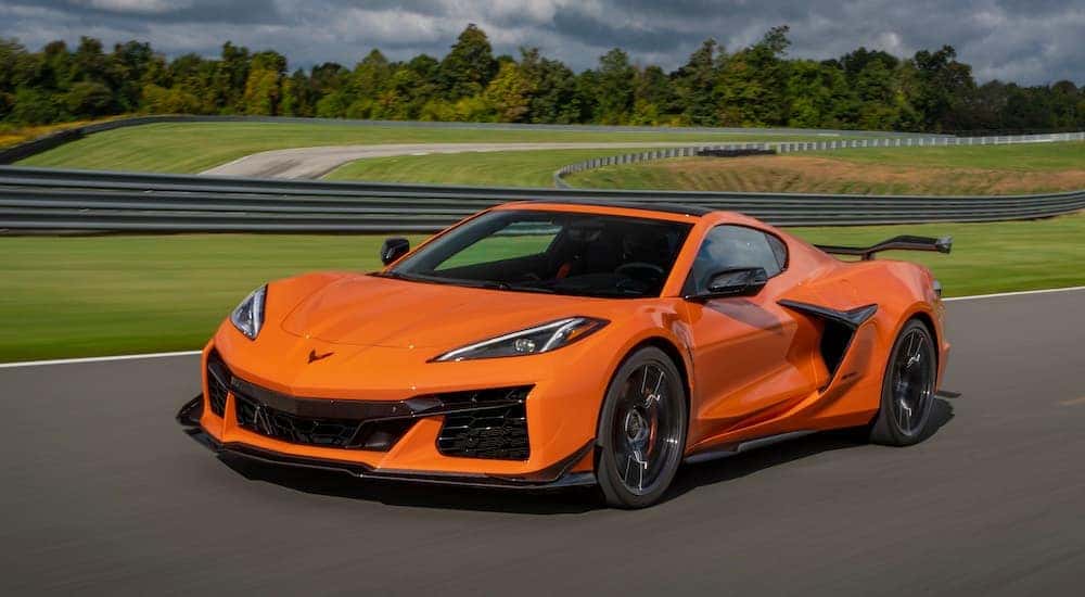 An orange 2023 Chevy Corvette Z06 is shown from the front at an angle after leaving a American Fork Chevy dealer.