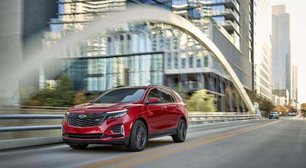A red 2024 Chevy Equinox RS is shown from the front at an angle after leaving a Chevy Equinox dealer.
