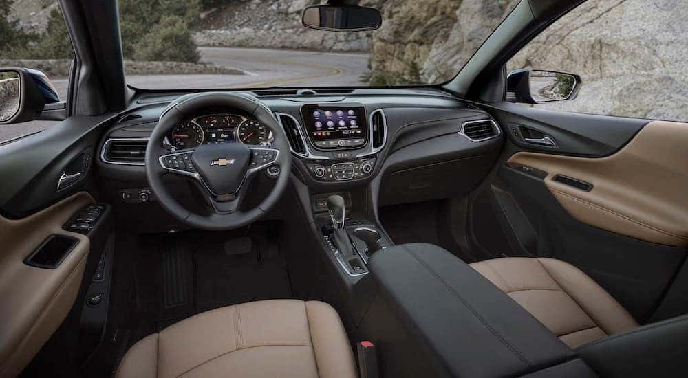 The brown interior of a 2024 Chevy Equinox is shown from the drivers seat.