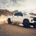 A white 2024 Chevy Silverado 1500 Z71 Trail Boss is shown from the front at an angle.