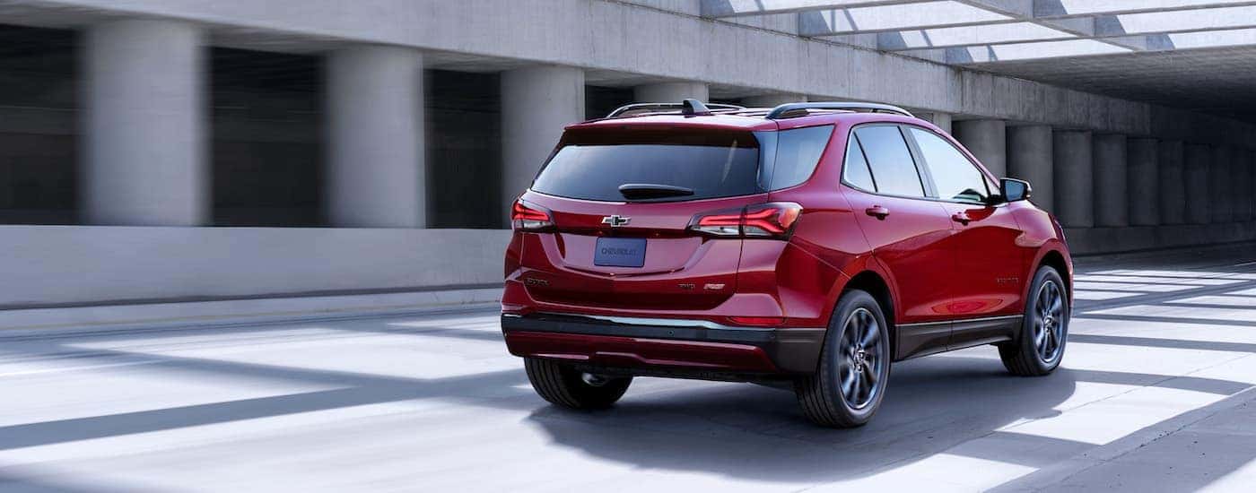 A red 2023 Chevy Equinox RS is shown from the rear at an angle.