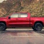 A red 2024 Chevy Silverado 1500 is shown from a side angle.