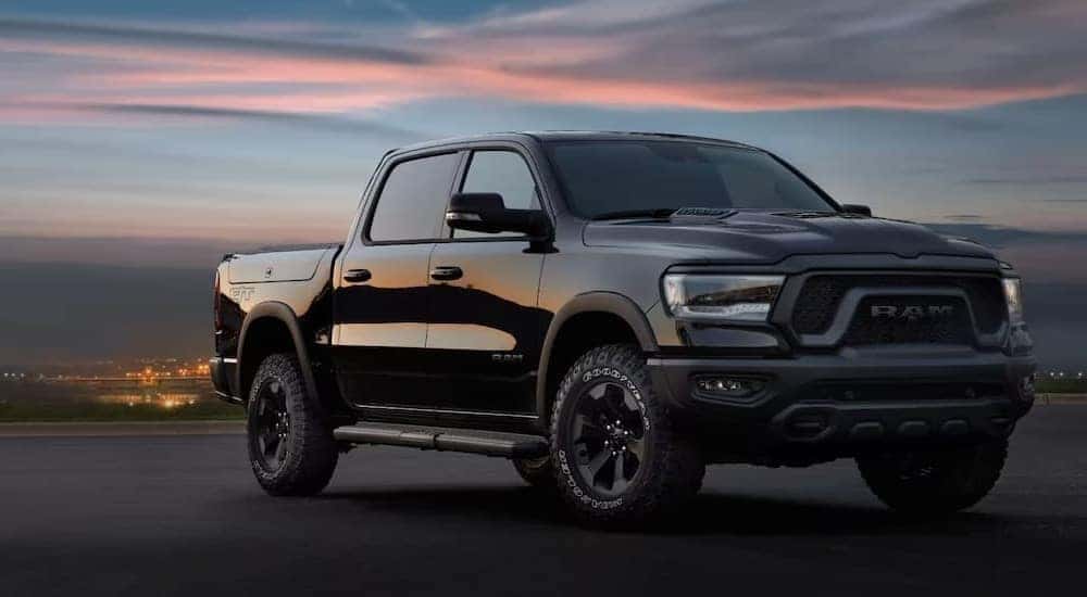 A black 2024 Ram 1500 GT is shown parked and angled right.