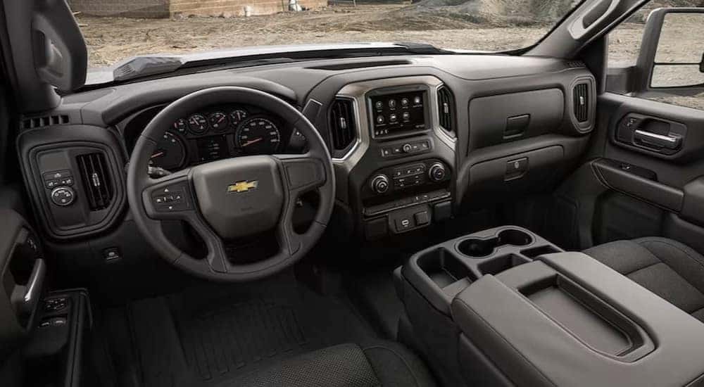 The black interior and dash in a 2023 Chevy Silverado 3500HD is shown.