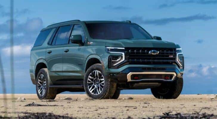 A green 2025 Chevy Tahoe Z71 parked on a sandy area.