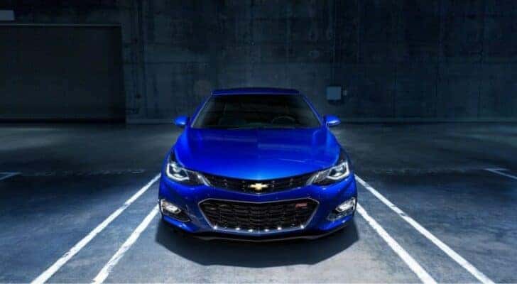 A blue 2017 Chevy Cruze RS is shown parked in a garage after leaving a used car dealer.