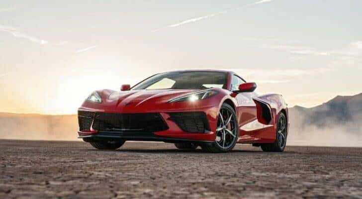 A red 2020 Chevy Corvette Stingray is shown parked off-road.