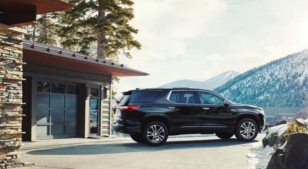 A black 2018 Chevy Traverse is shown parked near a garage.