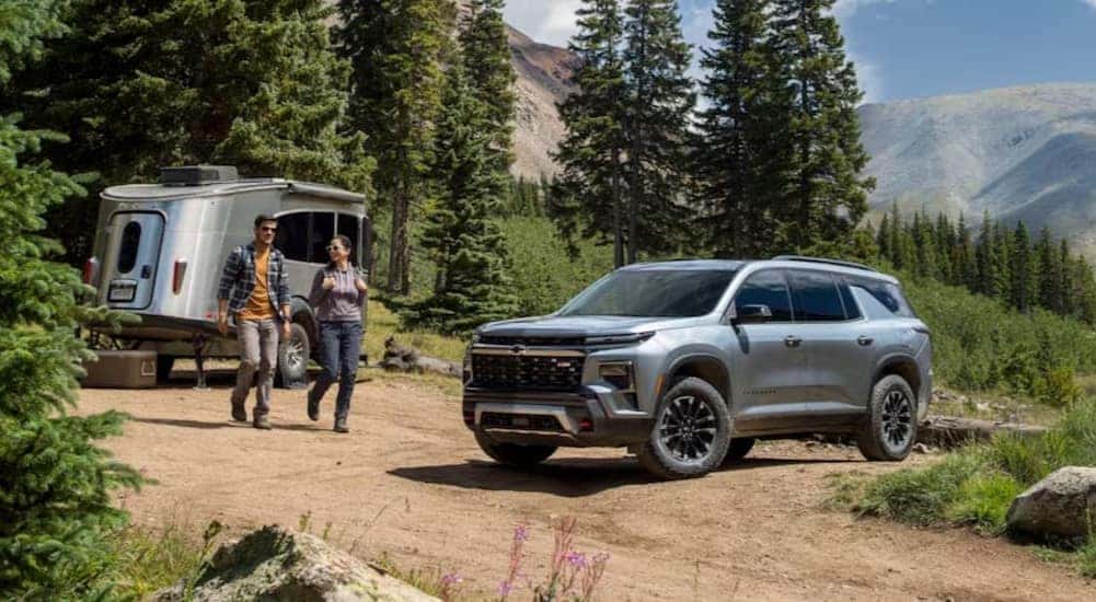 A silver 2025 Chevy Traverse Z71 is shown parked on a campsite.