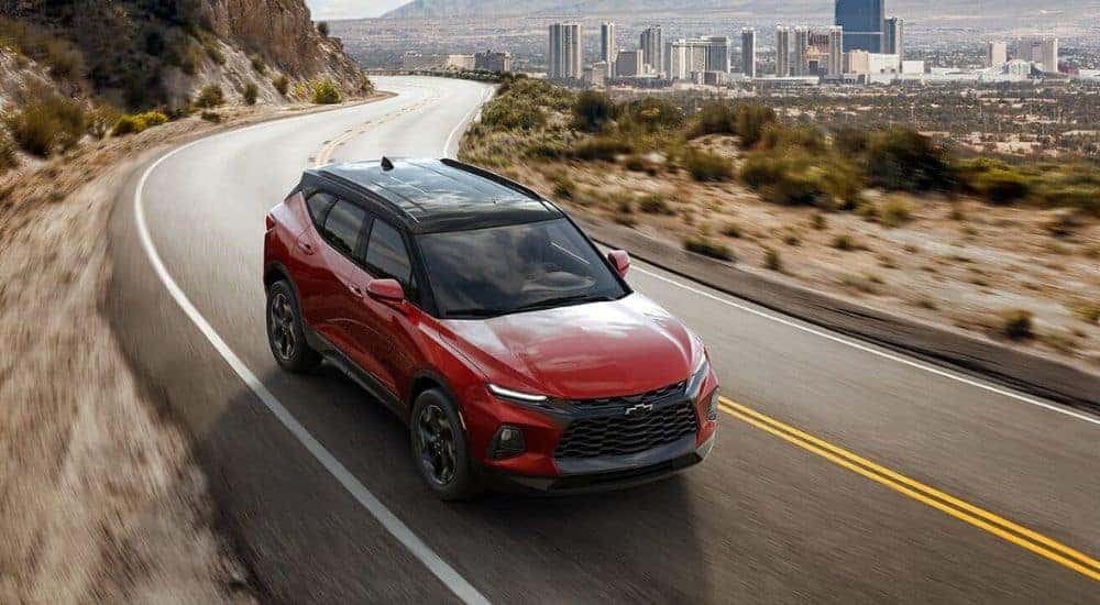Overhead view of a red 2021 Chevy Blazer RS driving to a dealer with used cars for sale.