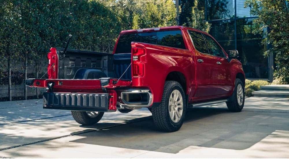 A red 2025 Chevy Silverado 1500 LTZ is shown parked on concrete.