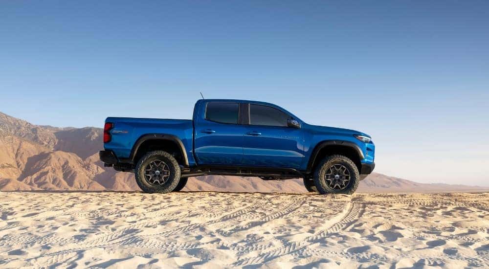 A blue 2023 Chevy Colorado ZR2 is shown from the side after visiting used car dealerships near you.