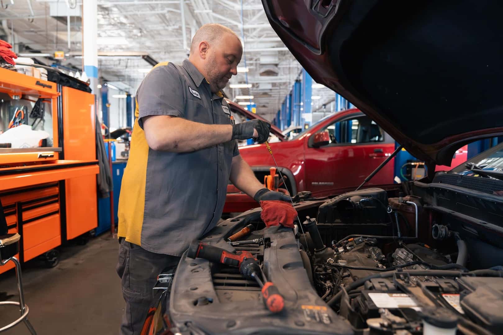 Person changing the oil on a vehicle