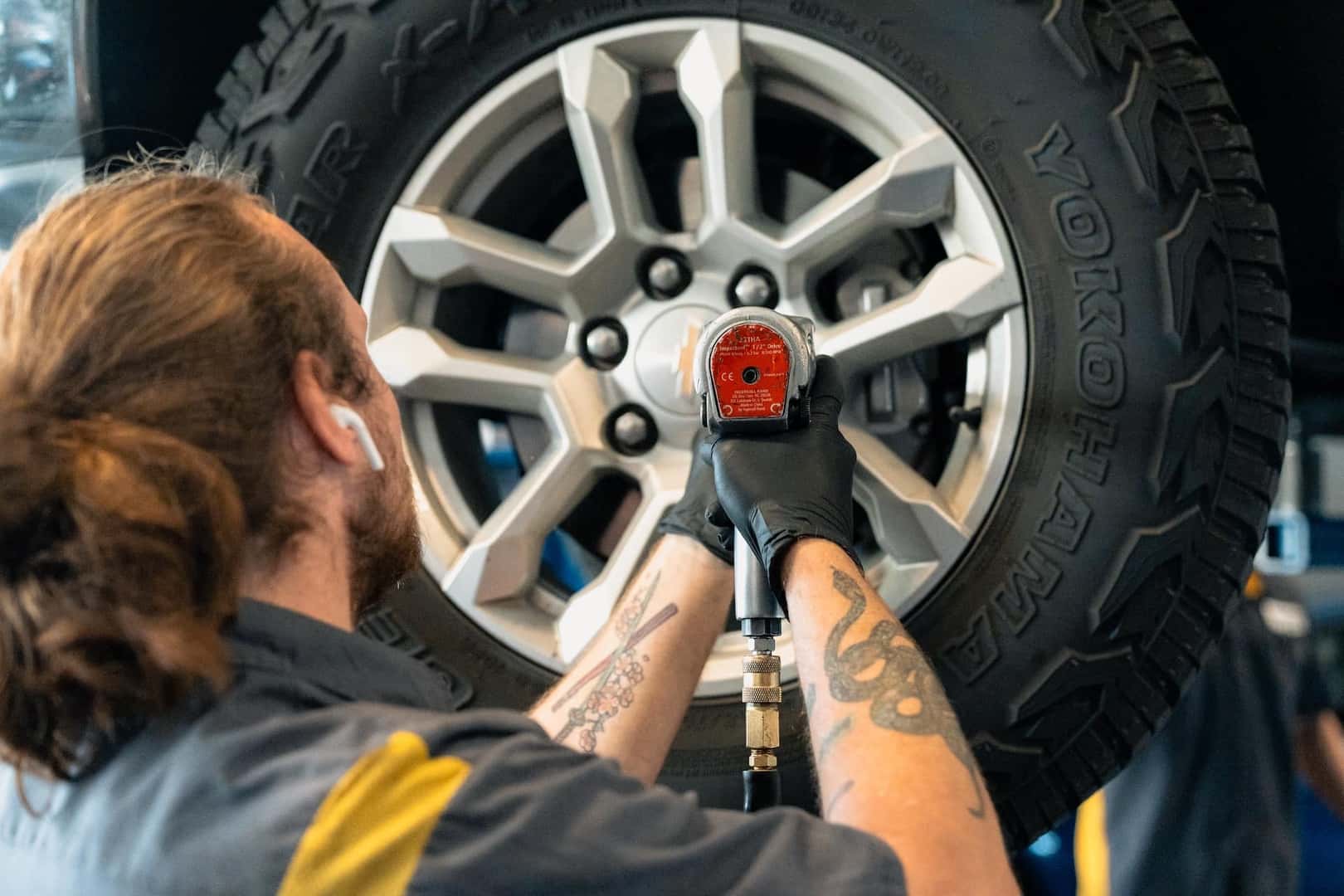 Person tightening lug nuts on tire wheel