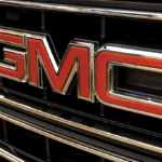 Close-up of red and chrome GMC logo on the grille of a vehicle