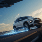 White Chevy SUV driving on the highway with an electric blue energy trail, featured by Riverton Elko