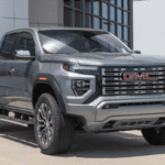 Gray GMC Sierra pickup parked outside Riverton Elko dealership building, front three-quarter view
